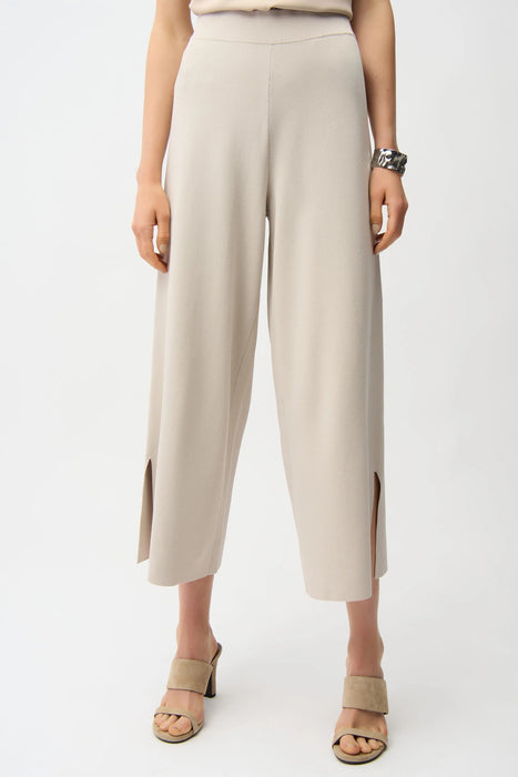 Woman wearing a beige cropped wide leg pants with side slit hem from Joseph Ribkoff