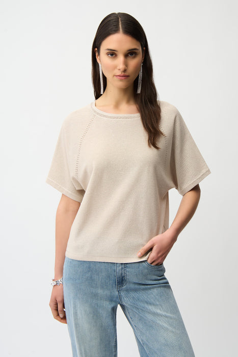 Woman wearing a beige short sleeve sweater top with sequins from Joseph Ribkoff