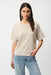 Woman wearing a beige short sleeve sweater top with sequins from Joseph Ribkoff