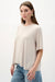 Woman wearing Joseph Ribkoff silky knit trapeze top styled for office wear, casual chic outfits, and modern everyday fashion looks.
