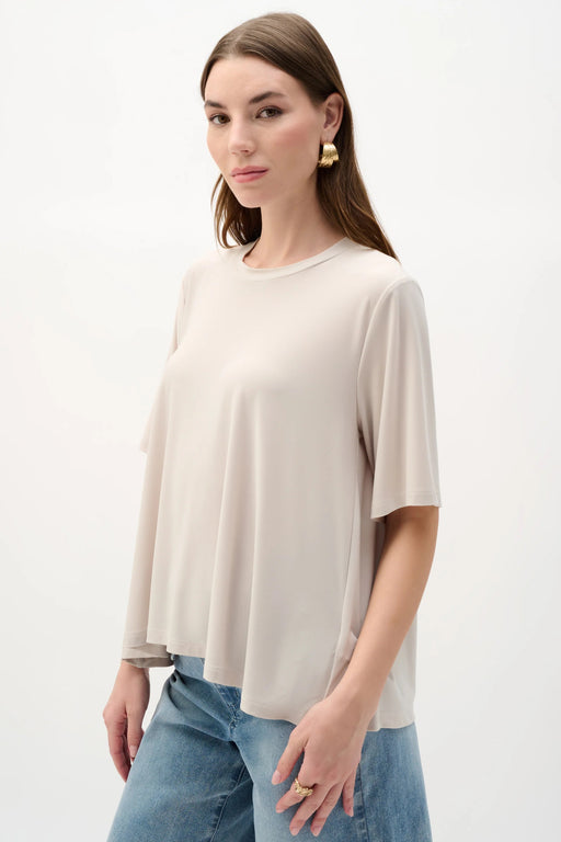 Woman wearing Joseph Ribkoff silky knit trapeze top styled for office wear, casual chic outfits, and modern everyday fashion looks.