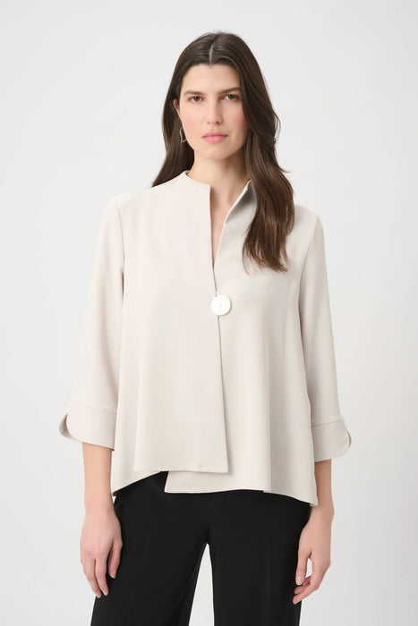 Woman wearing a solid light gray swing jacket with statement button and 3/4 sleeves from Joseph Ribkoff