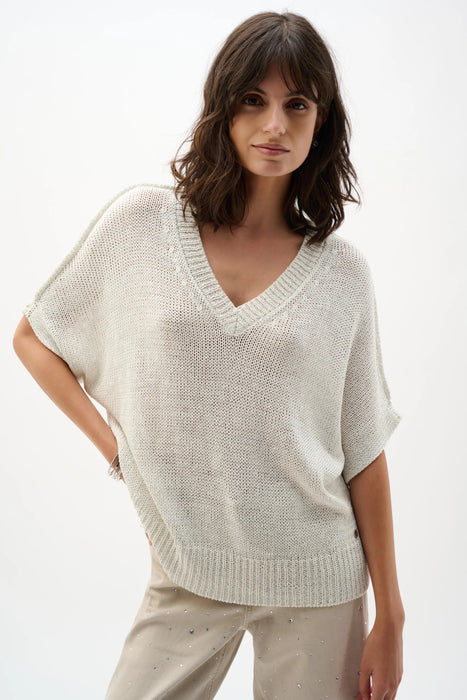 Woman wearing Joseph Ribkoff sweater knit relaxed top with metallic shimmer styled for casual chic, office wear, and elegant evening outfits.