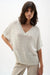 Woman wearing Joseph Ribkoff sweater knit relaxed top with metallic shimmer styled for casual chic, office wear, and elegant evening outfits.