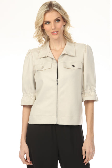 Woman wearing a beige zip front jacket with elbow-length puff sleeves from Joseph Ribkoff