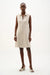 Woman wearing Joseph Ribkoff bouclé A-line dress with a zip neckline, featuring a textured fabric, sleeveless design, knee-length cut, and a flattering elegant fit.