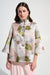 Woman wearing Joseph Ribkoff floral jacquard trapeze jacket with bell sleeves