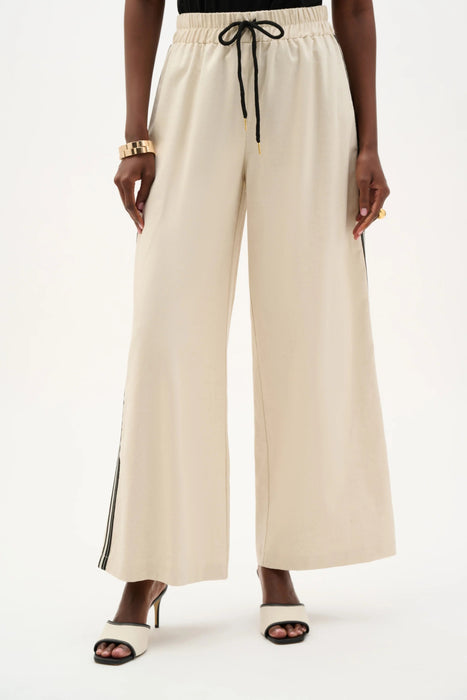 Woman wearing Joseph Ribkoff side stripe wide leg pull-on pants styled for office wear, travel outfits, casual chic looks, and modern tailored fashion.