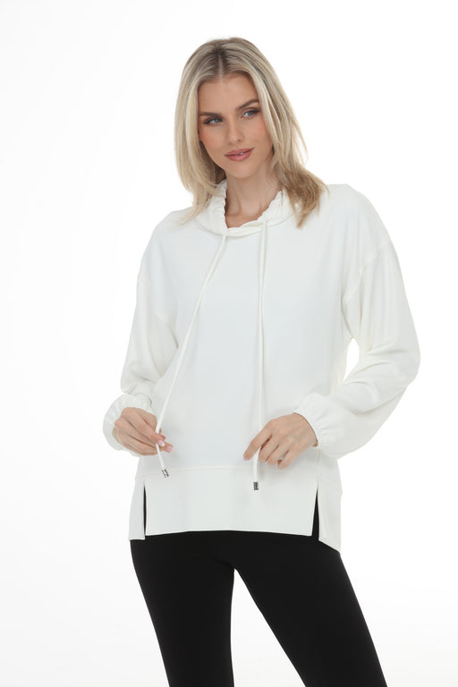 Woman wearing Joseph Ribkoff funnel neck tunic top for chic travel outfit