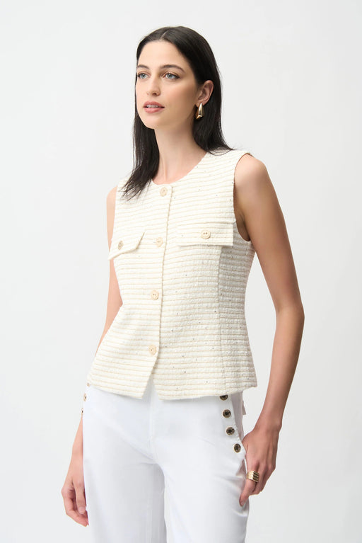 Woman wearing an off-white button front vest with gold stripes from Joseph Ribkoff