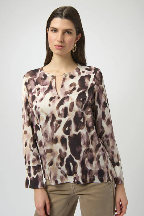 Woman wearing a lightweight animal printed top with chain keyhole neck detail