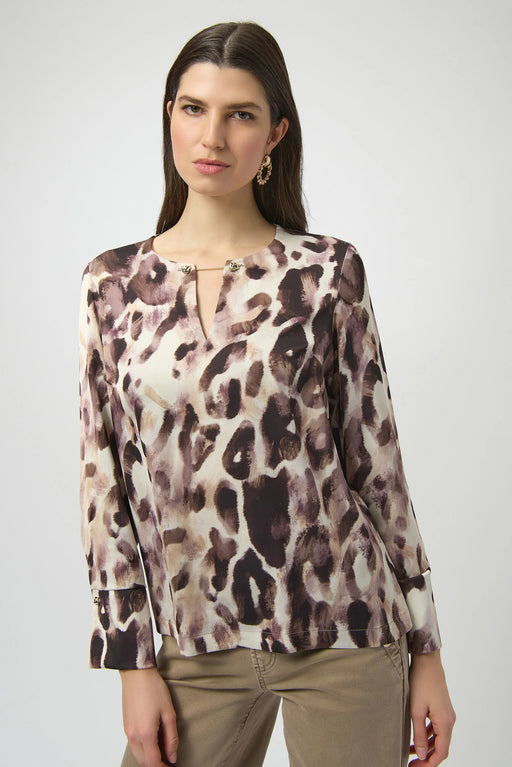 Woman wearing a lightweight animal printed top with chain keyhole neck detail