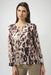 Woman wearing a lightweight animal printed top with chain keyhole neck detail