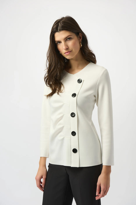 Woman wearing an off-white pleated front top with off-center button placket and long sleeves from Joseph Ribkoff