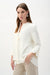 Woman wearing a solid off-white swing jacket with statement button and 3/4 sleeves from Joseph Ribkoff