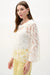 Woman wearing Joseph Ribkoff cowl neck boxy top for elegant office outfit