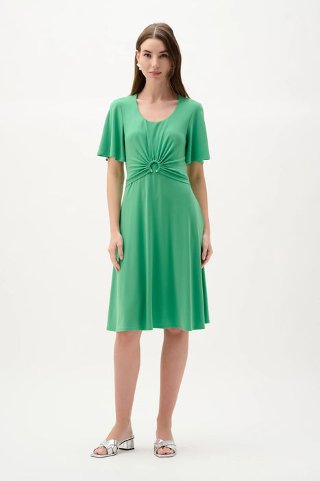 Woman wearing Joseph Ribkoff bell sleeve fit and flare dress with flowing skirt and elegant silhouette