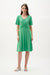 Woman wearing Joseph Ribkoff bell sleeve fit and flare dress with flowing skirt and elegant silhouette