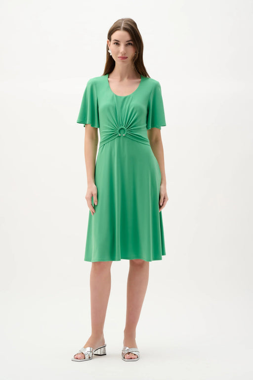 Woman wearing Joseph Ribkoff bell sleeve fit and flare dress with flowing skirt and elegant silhouette