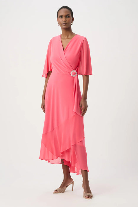 Woman wearing a pink dress with wrap neck and ruffle hem from Joseph Ribkoff