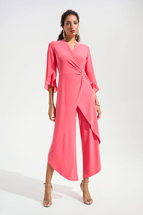 Woman wearing a pink wrap jumpsuit with 3/4 sleeves and cropped tulip wide leg from Joseph Ribkoff