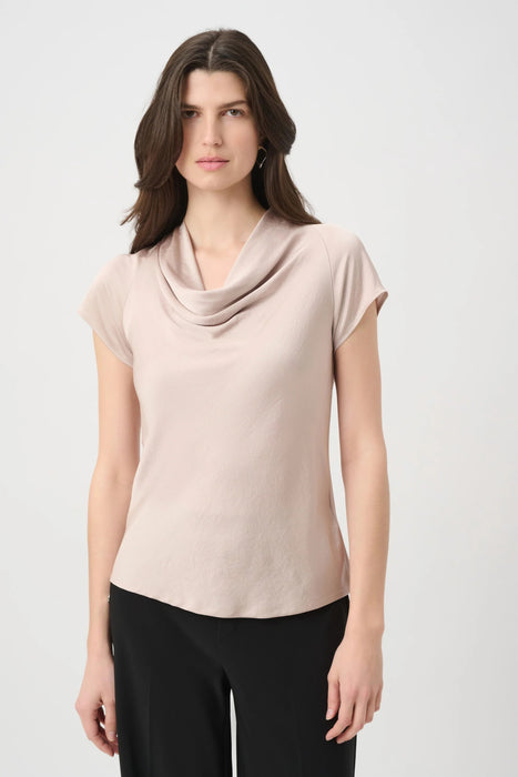 Woman wearing a beige cowl-neck top with raglan short sleeves from Joseph Ribkoff