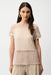 Woman wearing a beige textured short sleeve top with sheer mesh insert from Joseph Ribkoff
