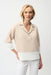 Woman wearing a parchment color block boxy top with shirt collar and dolman sleeves, styled for resort wear, travel, office chic, or casual elegant outfits.