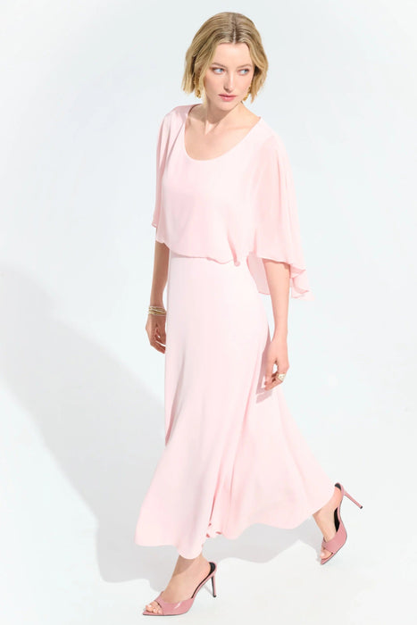 Woman wearing a light pink A-line maxi dress with lightweight chiffon overlay from Joseph Ribkoff