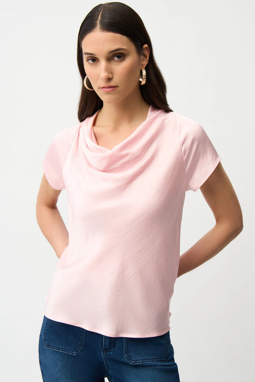 Woman wearing a light pink cowl-neck top with raglan short sleeves from Joseph Ribkoff