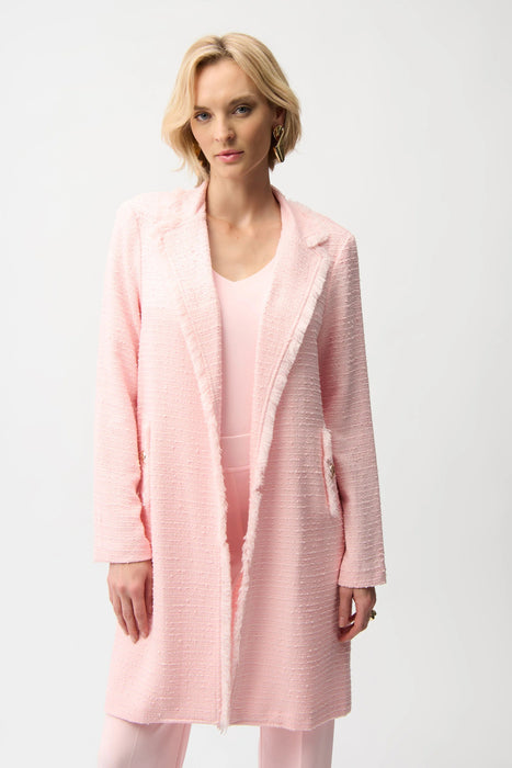 Woman wearing an open front pink coat with fringe trim and long sleeves from Joseph Ribkoff