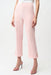 Woman wearing a light pink cropped high waist pants with gold rose buttons at the hem from Joseph Ribkoff