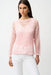 Woman wearing a pink open-knit sweater with sequins and long sleeves from Joseph Ribkoff