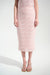 Woman wearing a light pink textured midi pencil skirt with pull on high waist from Joseph Ribkoff