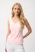 Woman wearing a petal pink sleeveless V-neck tank top, styled for office wear, travel, casual outings, or layered under a blazer for a polished look.