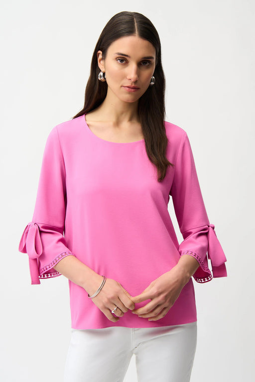 Woman wearing Joseph Ribkoff pink sherbet trapeze top with bell sleeves styled for brunch, office chic, casual outings, and elegant evening occasions.