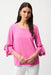 Woman wearing Joseph Ribkoff pink sherbet trapeze top with bell sleeves styled for brunch, office chic, casual outings, and elegant evening occasions.