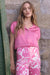 Woman wearing Joseph Ribkoff pink sherbet short sleeve blouse styled for office wear, brunch, casual outings, and modern feminine everyday fashion looks.