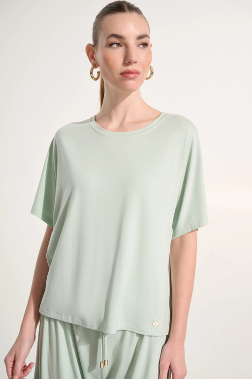 Woman wearing Joseph Ribkoff dolman sleeve boxy top styled for casual chic outfits, office casual wear, travel looks, and modern everyday fashion.
