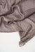 Close-up of a textured brown fabric on a white background