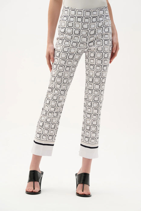 Woman in black and white printed straight leg trousers styled for business casual office look