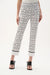 Woman in black and white printed straight leg trousers styled for business casual office look