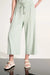 Woman wearing Joseph Ribkoff culotte pants with tie waist for casual day out