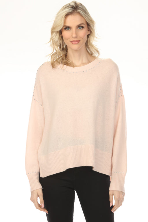 Woman wearing a light pink-colored crew neck sweater top with studs and long sleeves from Joseph Ribkoff