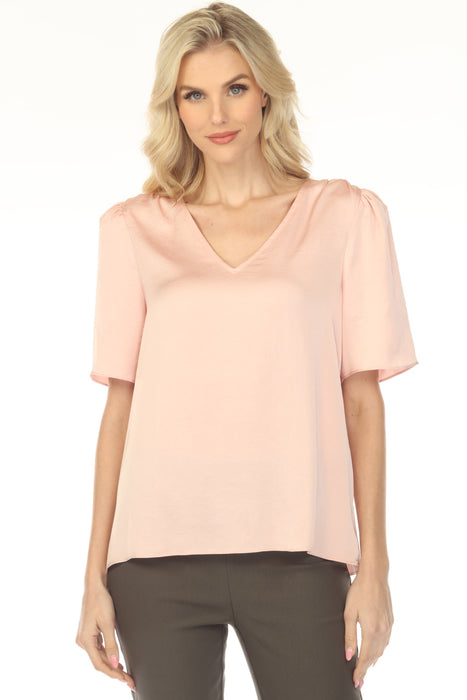 Woman wearing a light pink blouse with short sleeves and v-neck from Joseph Ribkoff