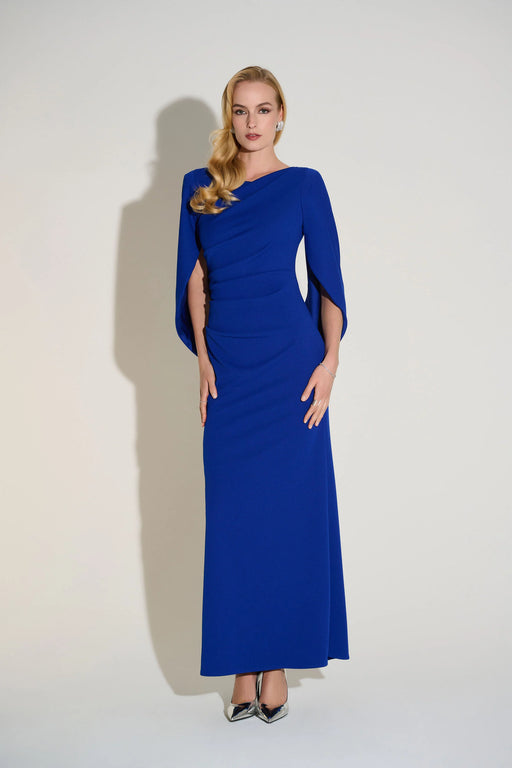 Woman wearing a blue evening gown with pleating and statement sleeves