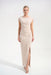 Woman wearing a beige long evening dress with ruching at the waist and rhinestone-trimmed side slit from Joseph Ribkoff