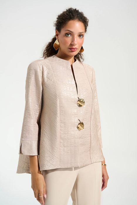 Woman wearing a beige jacket with gold buttons and 3/4 sleeves from Joseph Ribkoff
