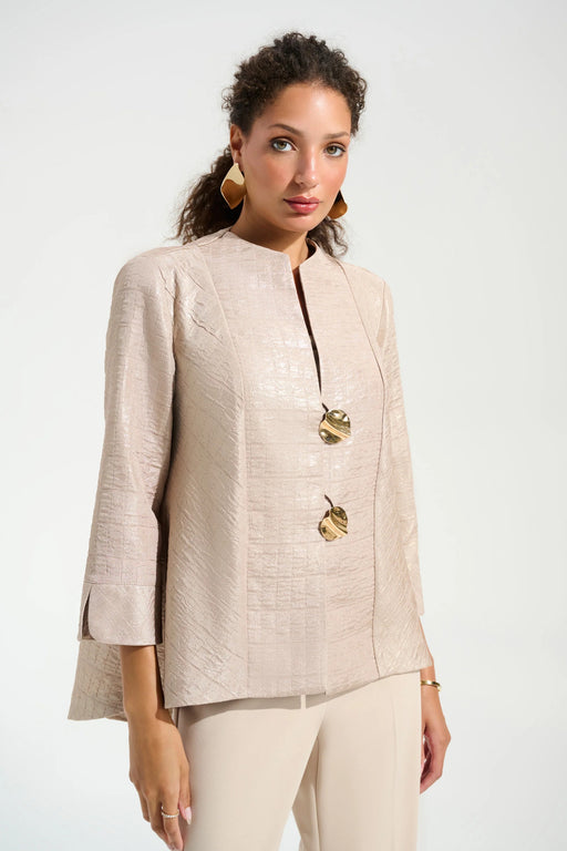 Woman wearing a beige jacket with gold buttons and 3/4 sleeves from Joseph Ribkoff