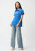 Woman wearing Joseph Ribkoff seersucker boxy top with memory collar, featuring a textured fabric, zip neckline, short sleeves, and a relaxed modern fit.